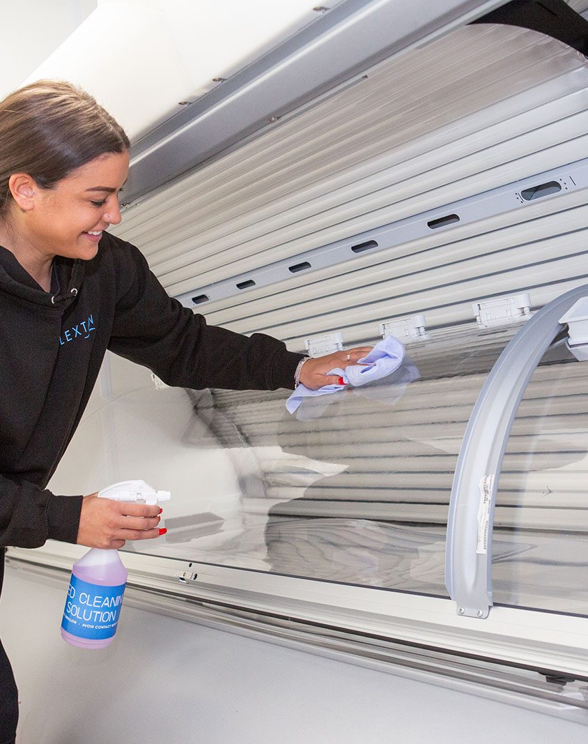 Dark haired woman cleaning a sunbed