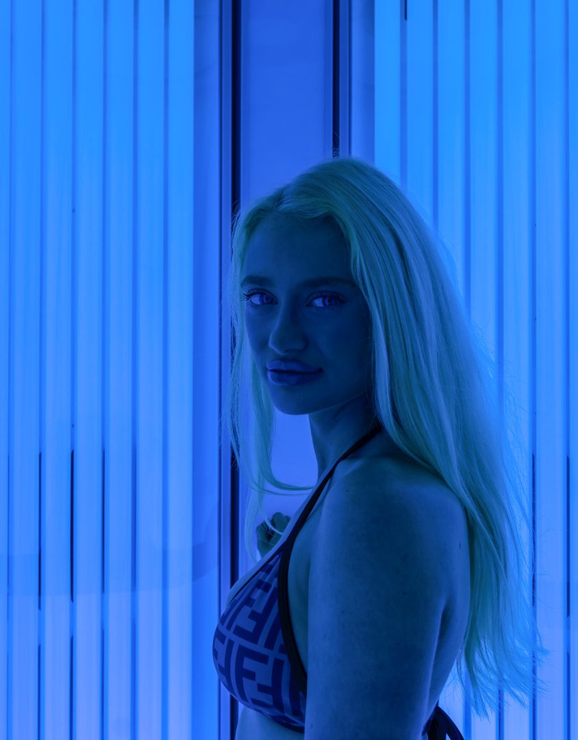 blonde woman in bikini in blue light